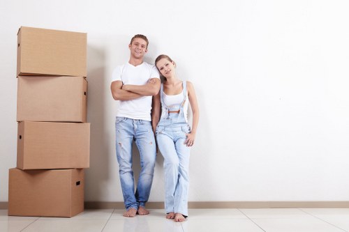 Urgent same day removals team handling furniture in Strand