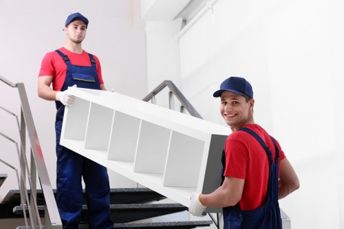 Removal team using safe lifting and carrying methods at a property