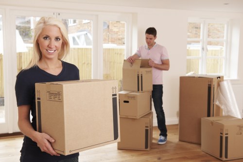 Students moving boxes with professional removal help in Strand