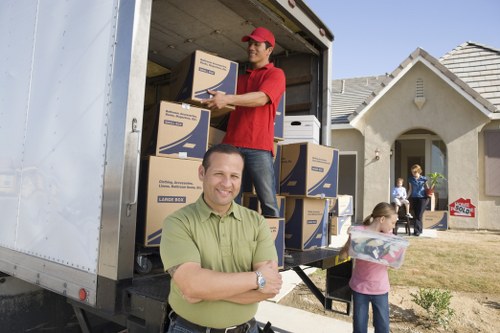 Professional moving team organizing items inside a removal van in Strand