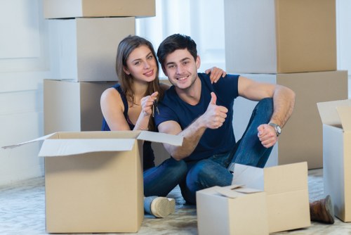 Professional movers packing office furniture for relocation