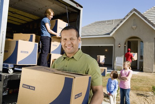 Same day removals crew transporting office items in Strand
